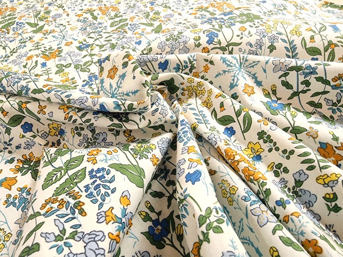 Tissu imprimé fleurs jaunes et bleues