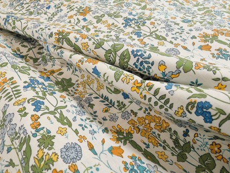 Tissu imprimé fleurs jaunes et bleues